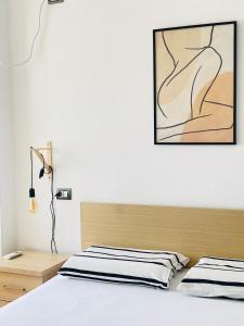 a bedroom with two beds and a painting on the wall at Mediterranean Sea Apartments in Durrës