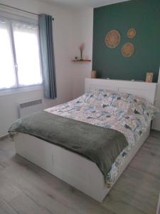 a bedroom with a bed with a quilt on it at Appartement 2 chambres parking Port Fréjus Base Nature in Fréjus