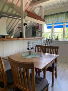 einen Holztisch und Stühle in der Küche in der Unterkunft Mysigt boende på landet nära naturen in Ödeshög + 15 Fotos