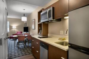 a kitchen and dining room with a dining table at TownePlace Suites Boone in Boone