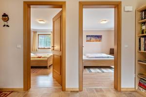 a room with a door leading to a bedroom at Obertegghof Wohnung Schartenblick in Sarntal