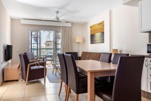 a kitchen and dining room with a table and chairs at Sunset Harbour Club in Adeje