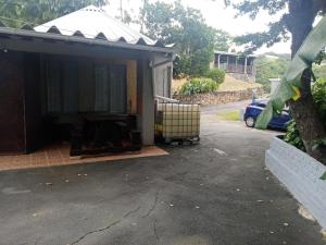 a garage with a car parked in a driveway at 17 Clubmed Resort in Hibberdene