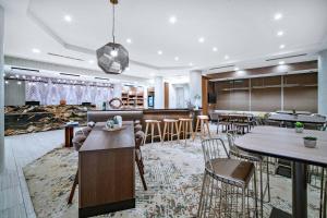 a lobby with tables and chairs and a bar at SpringHill Suites by Marriott Phoenix Goodyear in Goodyear