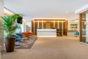 an office lobby with chairs and a reception desk at Royal Oasis Club at Pueblo Quinta in Benalmádena