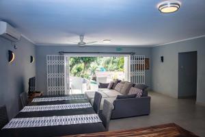 a living room with a couch and a table at Riverside Residence - BEAU VALLON in Beau Vallon