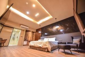 a bedroom with a bed and a black wall at Two Couples Leisure Art Motel in Tainan