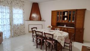 comedor con mesa con sillas y chimenea en La Casa di Bonaria, en Sestu