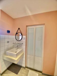 a bathroom with a sink and a shower at Woco Hotel Kinrara in Puchong
