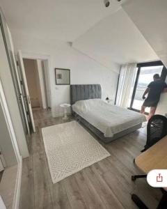 a bedroom with a bed and a person walking in it at Deniz manzaralı, sessiz konforlu in Dikili
