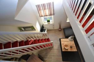 an attic room with a staircase and a living room at Tante Maaß in Flensburg