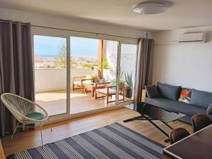 a living room with a couch and a large window at TERRAZA AL MAR in Aguadulce