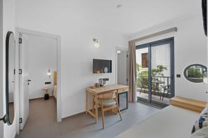 a room with a desk and a balcony at EGEDEN HOTEL in Datca