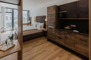 a bedroom with a large bed and a television at Apartments Landhaus Saalbach in Saalbach-Hinterglemm