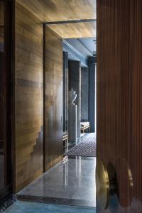a hallway of a building with wooden walls and a staircase at Nolinski Paris in Paris