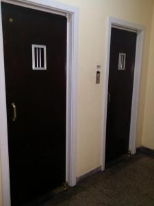 twee deuren in een kamer met zwarte deuren bij Estúdio Djalma Ulrich 91 2 in Rio de Janeiro