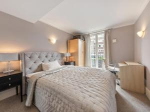 a bedroom with a large bed and a window at Chelsea in London