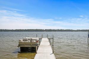 a boat parked at a dock on a lake at Lake Boat Hot Tub Sauna Private Chef in Shoreview