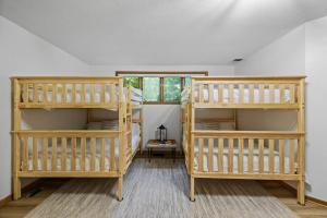two wooden bunk beds in a room with a window at Lake Boat Hot Tub Sauna Private Chef in Shoreview