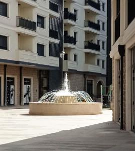 a water fountain in front of a building at Pine apartment in the center in Trebinje