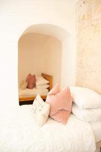 a bedroom with a bed with pillows on it at Garden flat in period property Centrally located in Bath