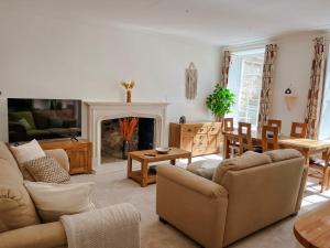 a living room with two couches and a fireplace at Garden flat in period property Centrally located in Bath