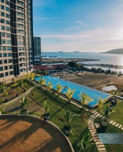 an overhead view of a large swimming pool in a city at Botiza Suites at Jesselton Quay in Kota Kinabalu