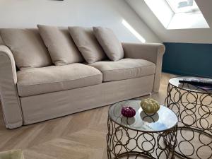 a living room with a couch and two tables at Appartement L’opale d’Anaé in Boulogne-sur-Mer