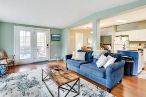 a living room with a blue couch and a table at Serene Sequim Retreat with Deck Pets Welcome! in Sequim