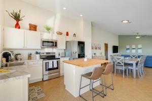 a kitchen with white cabinets and a table with chairs at Stunning Phoenix Vacation Rental with Private Pool! in Phoenix