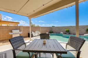 a patio with a table and chairs and a pool at Stunning Phoenix Vacation Rental with Private Pool! in Phoenix
