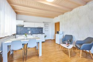 a kitchen and dining room with a table and chairs at Villa Gap apartments in Český Krumlov