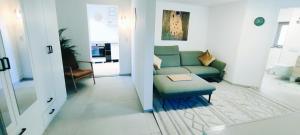 a living room with a couch and a table at Wohlfühloase im Herzen von Wiedenbrück in Rheda-Wiedenbrück