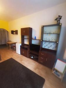 a living room with a large entertainment center and a flat screen tv at Hostinec u Kačaby in Jihlava