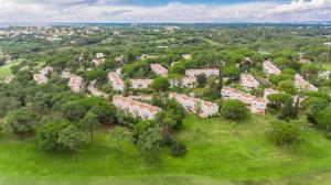 an aerial view of a campus with trees and buildings at Vilar do Golf in Quinta do Lago