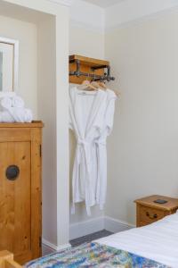 a bedroom with white towels hanging on a rack at Finest Retreats - Pittodrie Guest House - Room 3 in Brighton & Hove