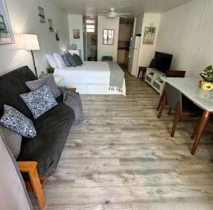 a living room with a bed and a couch at KASA Poolside Balcony for 2 in San Juan +24 photos