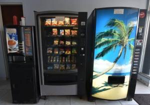 a soda machine with a palm tree painted on it at KASA Poolside Balcony for 2 in San Juan