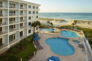 an aerial view of a hotel with two pools and the beach at SpringHill Suites by Marriott Pensacola Beach in Pensacola Beach