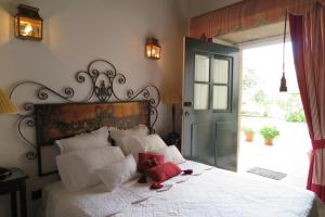 a bed with two stuffed animals on it in a bedroom at Solar de Santa Maria in Bragança