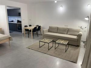 a living room with a couch and a table at oR-Ya Suite in Eilat
