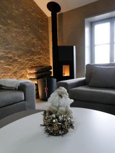 a stuffed animal sitting on a table in a living room at Le patio d'antan, le cosy in Florémont