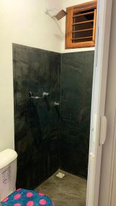 a bathroom with a shower with a green wall at L2 Localize casa na praia pontal in Fortim +36 photos
