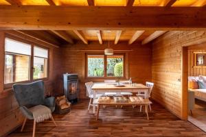 a dining room with a table and a fireplace at Panoramic Chalet Hot Tub, BBQ, view, terrace in Gönnersdorf +12 photos