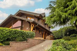 a house with a staircase leading up to it at Panoramic Chalet Hot Tub, BBQ, view, terrace in Gönnersdorf