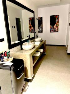 a bathroom with two sinks and a large mirror at Epic Suites Bohol ADULTS ONLY in Dauis