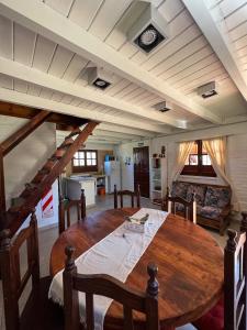 a dining room with a wooden table and chairs at Apart del Valle in Tafí del Valle