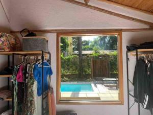 a room with a window and a swimming pool at Casa da Rê in Serra do Cipo