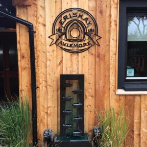 a sign on the side of a building with a spiral staircase at Eriskay B&B and Aviemore Glamping in Aviemore