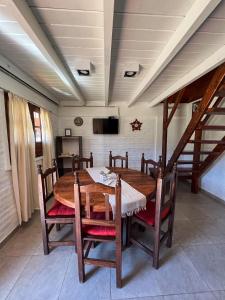 a dining room with a wooden table and chairs at Apart del Valle in Tafí del Valle